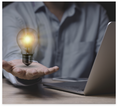 businessman-holding-lightbulb-which-glowing-wooden-table-with-laptop-computer-as-business-solution-creative-marketing-idea-conc
